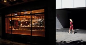 A split-screen view shows a warm, illuminated bar interior on the left and a woman in a pink dress walking in a shadowed alleyway on the right.