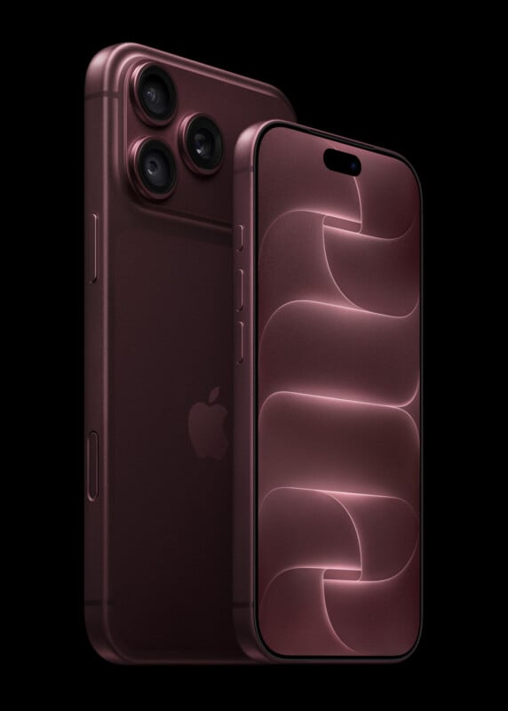 Two smartphones in a deep burgundy color are positioned against a black background, with one showing its back camera array and the other displaying a matching abstract wallpaper on its screen.