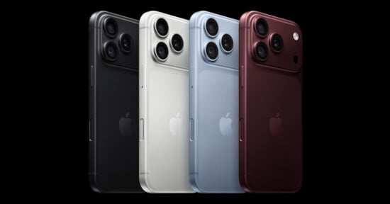 Four smartphones in black, white, light blue, and dark red are arranged in a row against a black background, each featuring a triple-lens camera array.