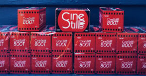A stack of red CineStill 800T 35mm film boxes arranged in three rows against a dark blue background.