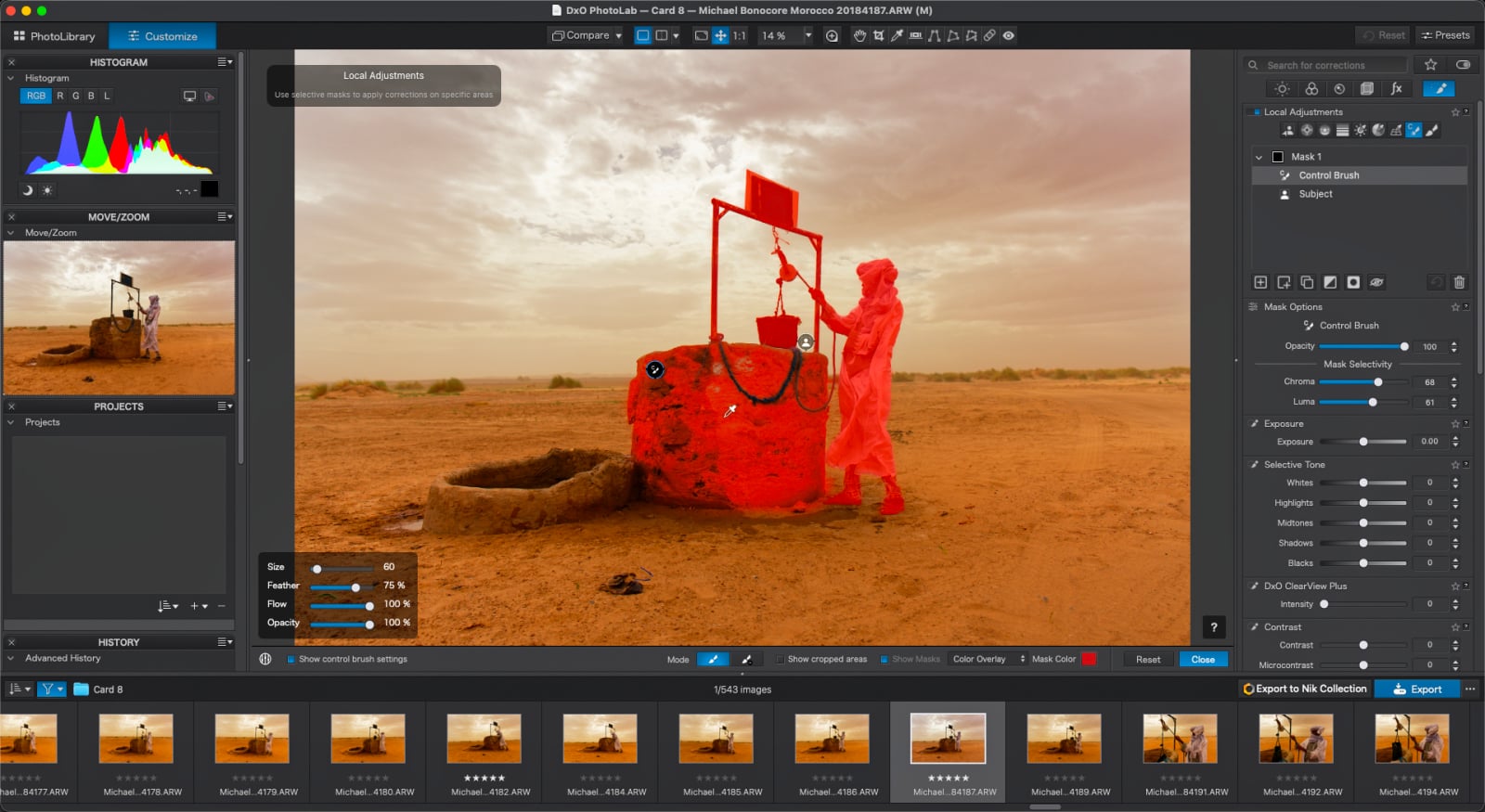 A screenshot of the DxO PhotoLab software interface showing a desert scene with a person at a well, where a red mask is applied to the subject and the well structure for local adjustments.