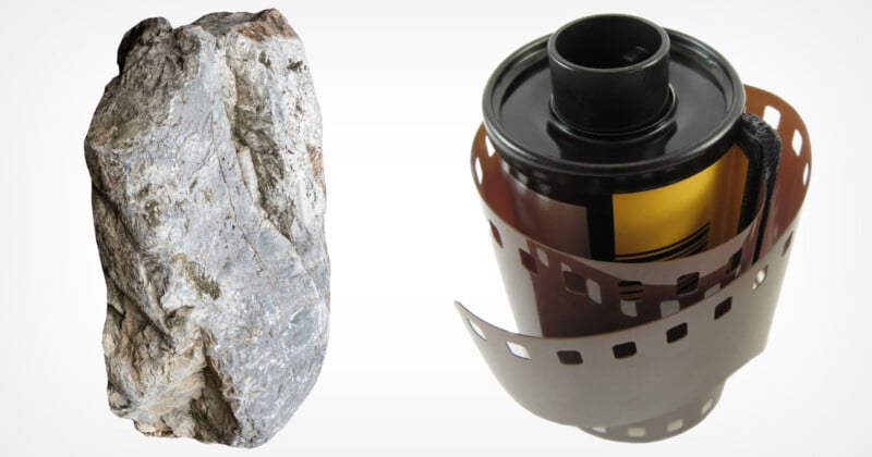 A grey, textured rock stands next to a roll of 35mm photographic film on a white background.