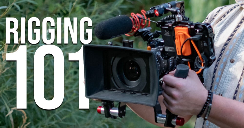 A person holds a professional cinema camera rig equipped with a matte box, a shotgun microphone, and an external monitor, with the text "RIGGING 101" overlaid on the left.
