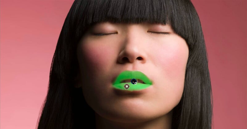 A person with dark hair and closed eyes wears bright green lipstick against a solid pink background.
