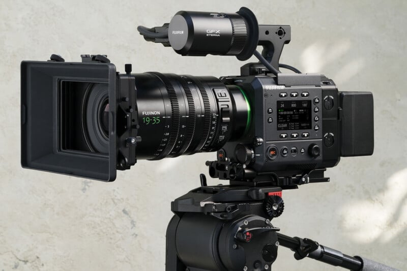 A professional cinema camera mounted on a tripod, featuring a Fujinon 19-35 lens, a matte box, and a GFX Eterna viewfinder.