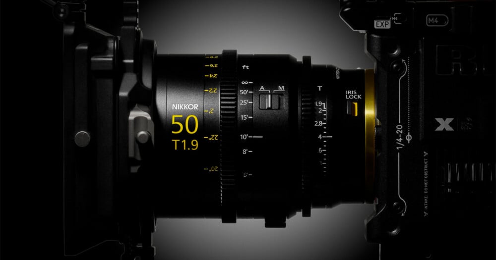 A side view of a cinema lens attached to a camera body, showing focus and iris markings, including the text "NIKKOR 50 T1.9".