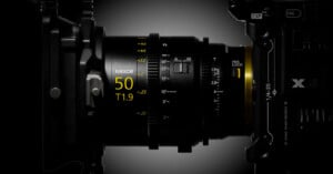 A side view of a cinema lens attached to a camera body, showing focus and iris markings, including the text "NIKKOR 50 T1.9".