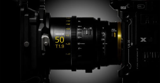 A side view of a cinema lens attached to a camera body, showing focus and iris markings, including the text "NIKKOR 50 T1.9".
