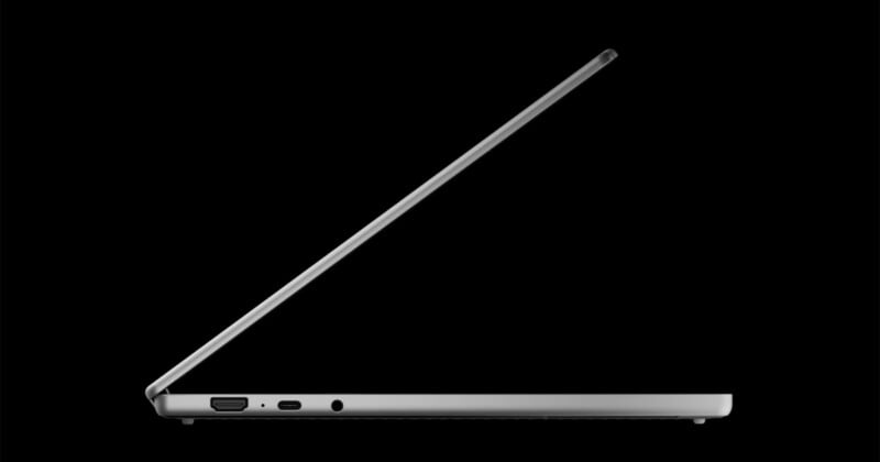 A side profile of a silver laptop with its screen partially open, showing an HDMI port, a USB-C port, and a headphone jack on its edge against a black background.