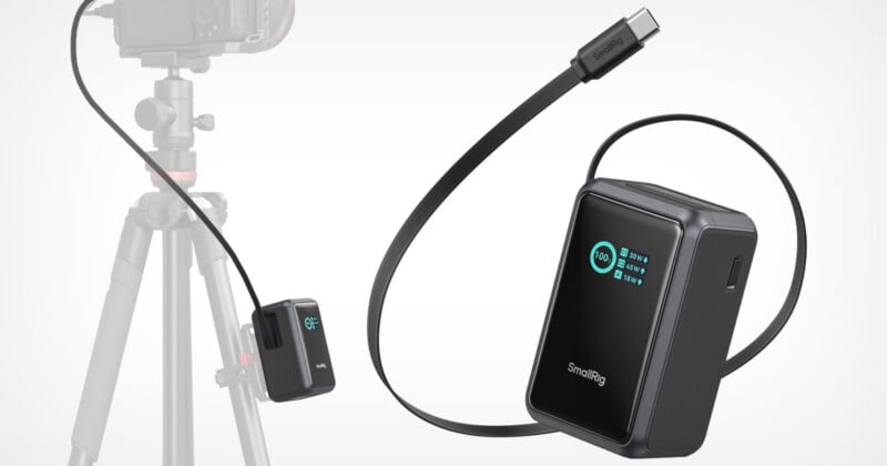 A SmallRig power bank with a digital display showing battery percentage and port wattage is shown next to a camera mounted on a tripod, with a cable connecting the two.