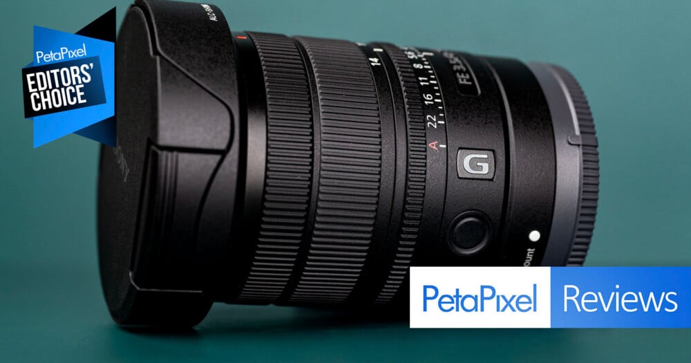 A black Sony G-series camera lens sits on a dark green surface, with a PetaPixel Editors' Choice badge on the left and a PetaPixel Reviews logo in the bottom right.