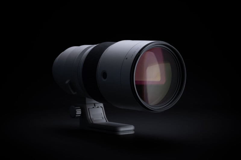 A telephoto camera lens with a tripod mount sits against a solid black background.