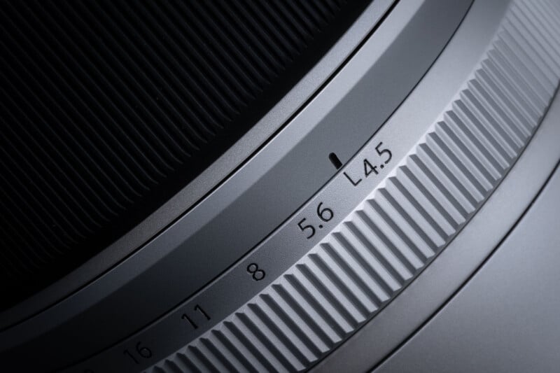 A close-up view of a camera lens barrel showing an aperture ring with markings for 4.5, 5.6, 8, 11, and 16, with a black indicator line set to 5.6.