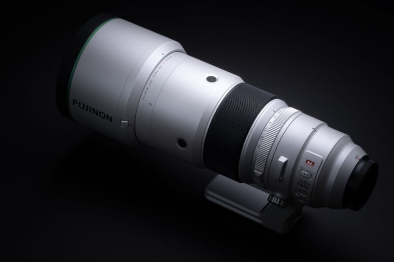 A silver Fujinon XF 400mm telephoto lens sits against a solid black background.
