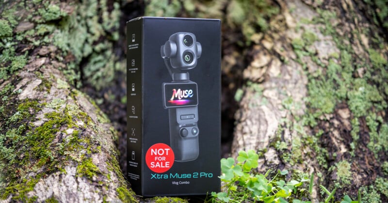 A black product box for the Xtra Muse 2 Pro Vlog Combo sits on a mossy tree trunk, featuring a large red "NOT FOR SALE" sticker.