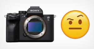 A black Sony Alpha 7s camera body with an exposed sensor next to a yellow emoji with a skeptical expression.
