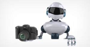 A white and dark blue robot holds a black camera in its right hand against a plain white background.
