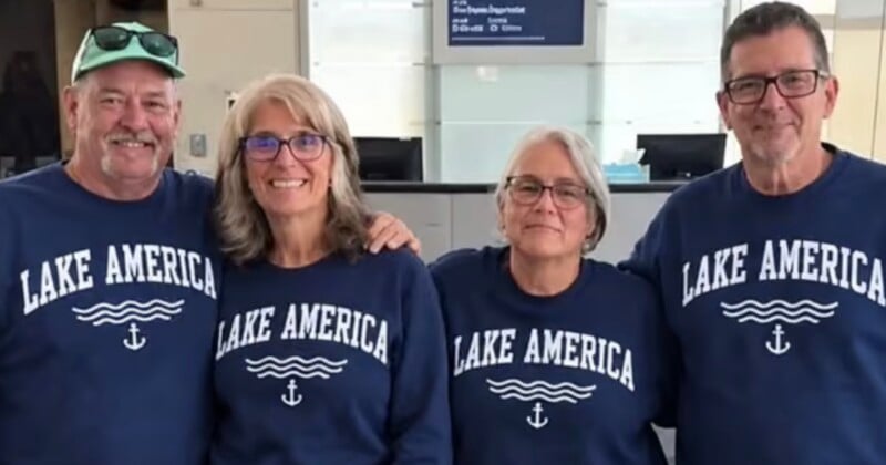 Four people stand side-by-side wearing matching navy blue sweatshirts that say "LAKE AMERICA" with a wave and anchor graphic.