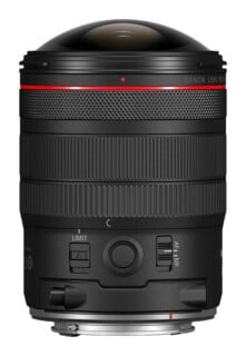 A black Canon RF lens with a prominent, rounded front element, a red ring near the top, and focus and control rings, shown against a white background.