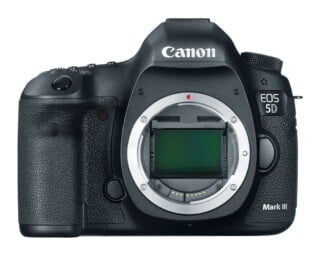 A front-facing Canon EOS 5D Mark III digital SLR camera body with the lens removed, revealing the sensor and lens mount.
