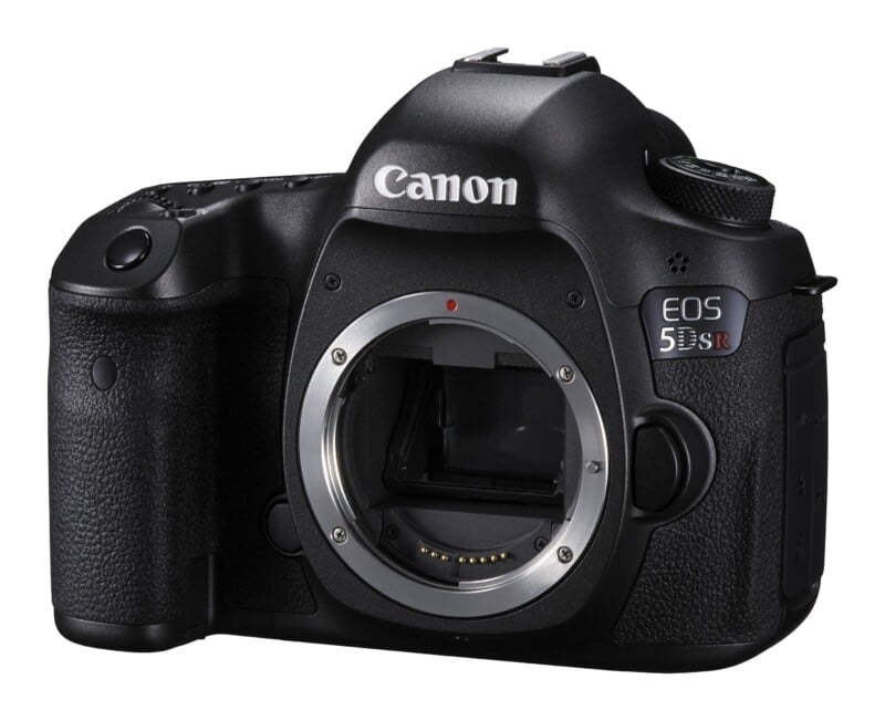 A black Canon EOS 5DS R DSLR camera body shown from the front without a lens attached.