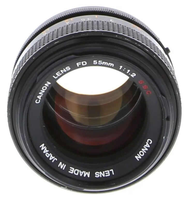 A front view of a Canon FD 55mm 1:1.2 S.S.C. camera lens with a black metal body and glass elements.