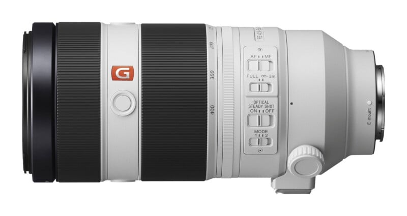 A white Sony FE 100-400mm f/4.5-5.6 GM OSS telephoto zoom lens shown from the side, featuring focus and stabilization switches.