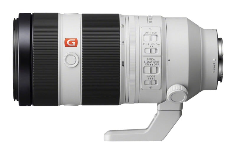 A white Sony E-mount telephoto zoom lens with a black focus ring, a zoom ring marked from 135 to 400, and several control switches on the side.