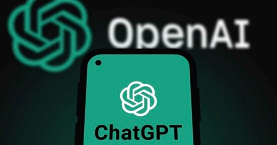 A smartphone screen displays the ChatGPT logo and text against a dark background featuring a large, blurred OpenAI logo.