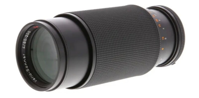 A black Vario-Sonnar 4/80-200 camera lens positioned at an angle against a white background.