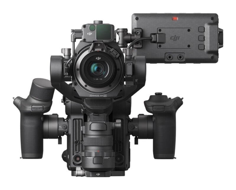 A professional cinema camera rig with a gimbal-mounted lens, two side handgrips, and a side-mounted monitor screen.