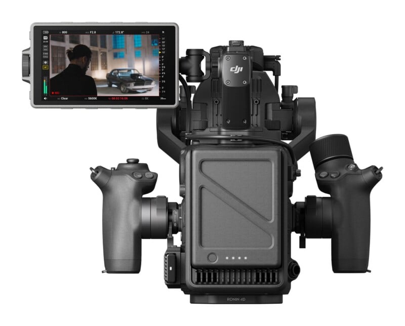 A rear view of a DJI Ronin 4D cinema camera system with a side-mounted monitor displaying a video feed of a person and a car.