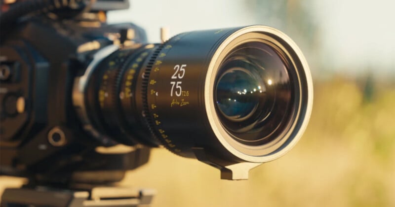 A close-up of a professional cinema lens mounted on a camera, with "25 75 T2.6 Arles Zoom" printed on the barrel.