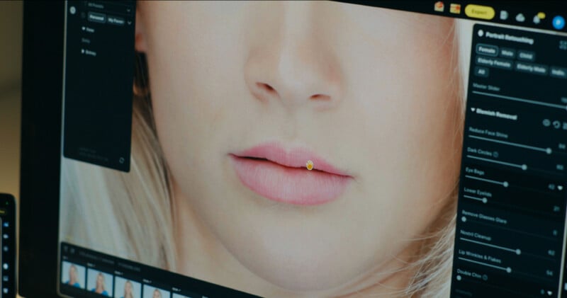 A computer monitor displays a photo editing interface showing a close-up of a person's face with a hand-shaped cursor over the lips.