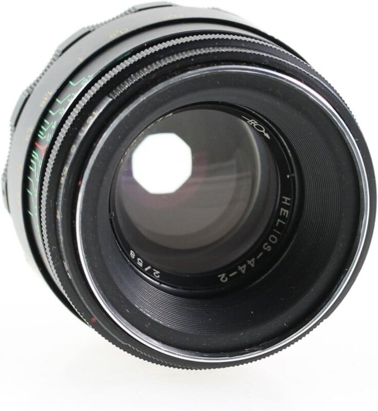 A black Helios-44-2 2/58 camera lens viewed from the front, showing the glass elements and aperture blades.