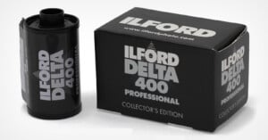 A 35mm film canister and its matching box, both labeled Ilford Delta 400 Professional Collector's Edition, sit on a white surface.