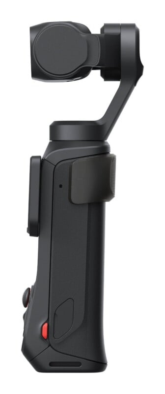 A side view of a black handheld gimbal camera with a three-axis stabilizer and a red record button on the handle.