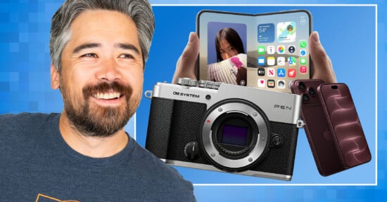 A man with a beard smiles next to a floating OM SYSTEM PEN camera, a foldable smartphone, and a dark purple smartphone against a blue background.