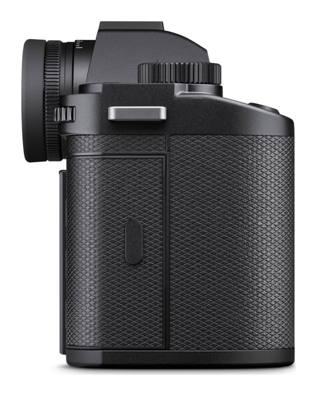 A side view of a black digital camera body with a textured grip and a prominent electronic viewfinder eyepiece.