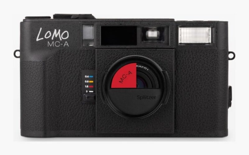 A black Lomo MC-A film camera with a red Splitzer lens attachment, featuring a focus distance selector on the front body.