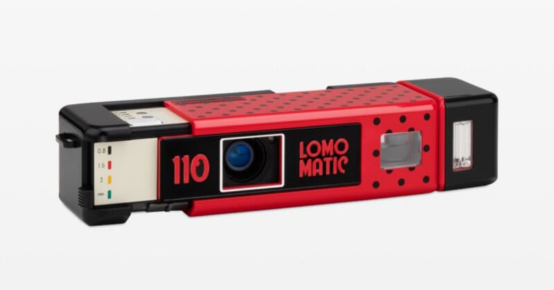 A red and black LomoMatic 110 film camera with a polka-dot pattern, shown from a front-facing angle against a white background.