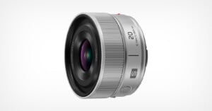 A silver Panasonic Lumix S-series 20mm f/2.5 prime lens viewed from a side angle against a white background.