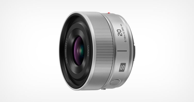 A silver Panasonic Lumix S-series 20mm f/2.5 prime lens viewed from a side angle against a white background.