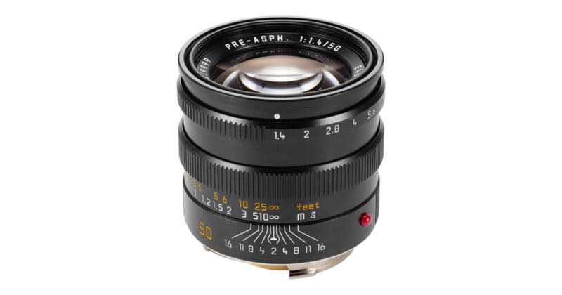 A black 50mm f/1.4 camera lens with manual focus and aperture rings, featuring white and yellow markings on a white background.