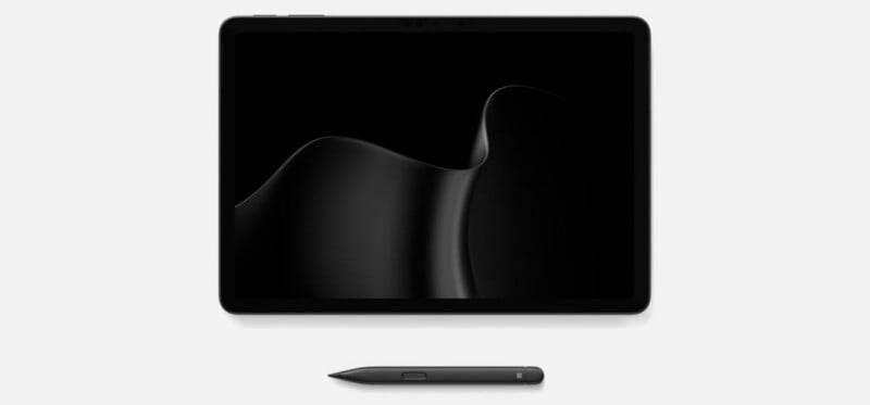 A black tablet with a dark abstract wallpaper and a matching stylus pen positioned horizontally below it on a plain white background.