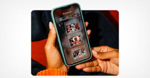 A person holds a smartphone displaying the Mixbook app, which shows a chronological feed of photo memories from September 12.