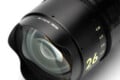 A close-up, angled view of a black NiSi 26mm f/0.7 full-frame camera lens with yellow text markings on the barrel.