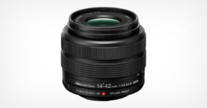 A black OM SYSTEM 14-42mm f/3.5-5.6 II MSC zoom lens for mirrorless cameras, shown against a white background.