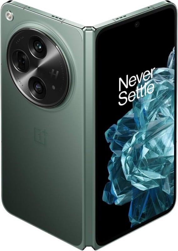 A sage green foldable smartphone is shown partially open, displaying a screen with the text "Never Settle" and a large circular camera module on the back.