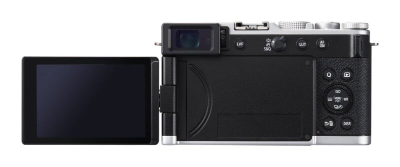 The back of a silver and black digital camera with an articulating screen extended to the left, featuring various buttons, a viewfinder, and a control dial.